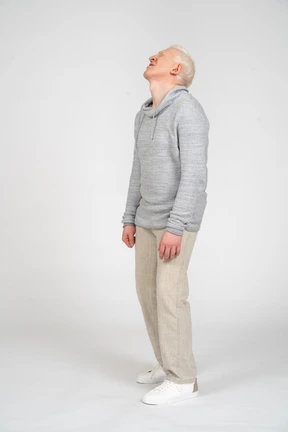 Three-quarter view of a man standing with head tilted back
