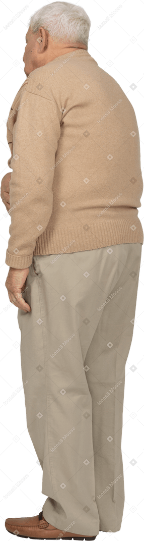 Side view of an old man in casual clothes suffering from stomachache