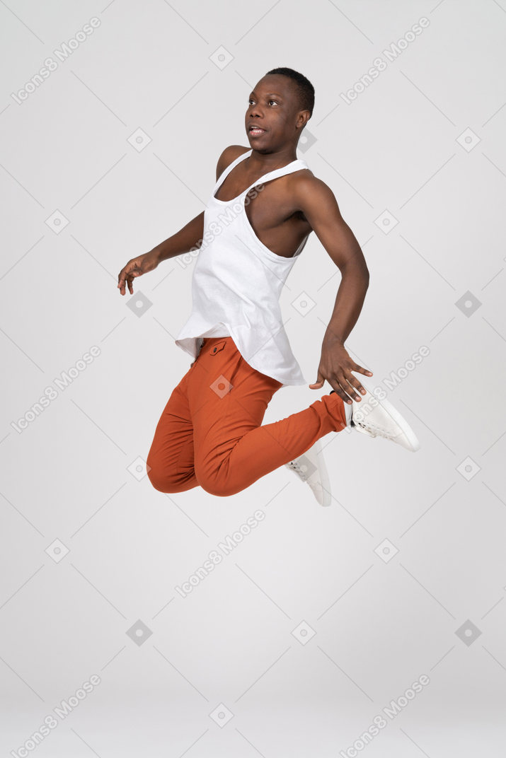 Young man jumping with folded legs