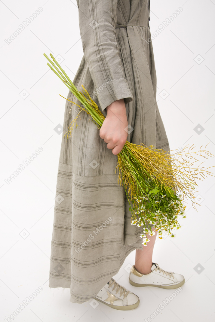 Female hands holding bouquet of field flowers
