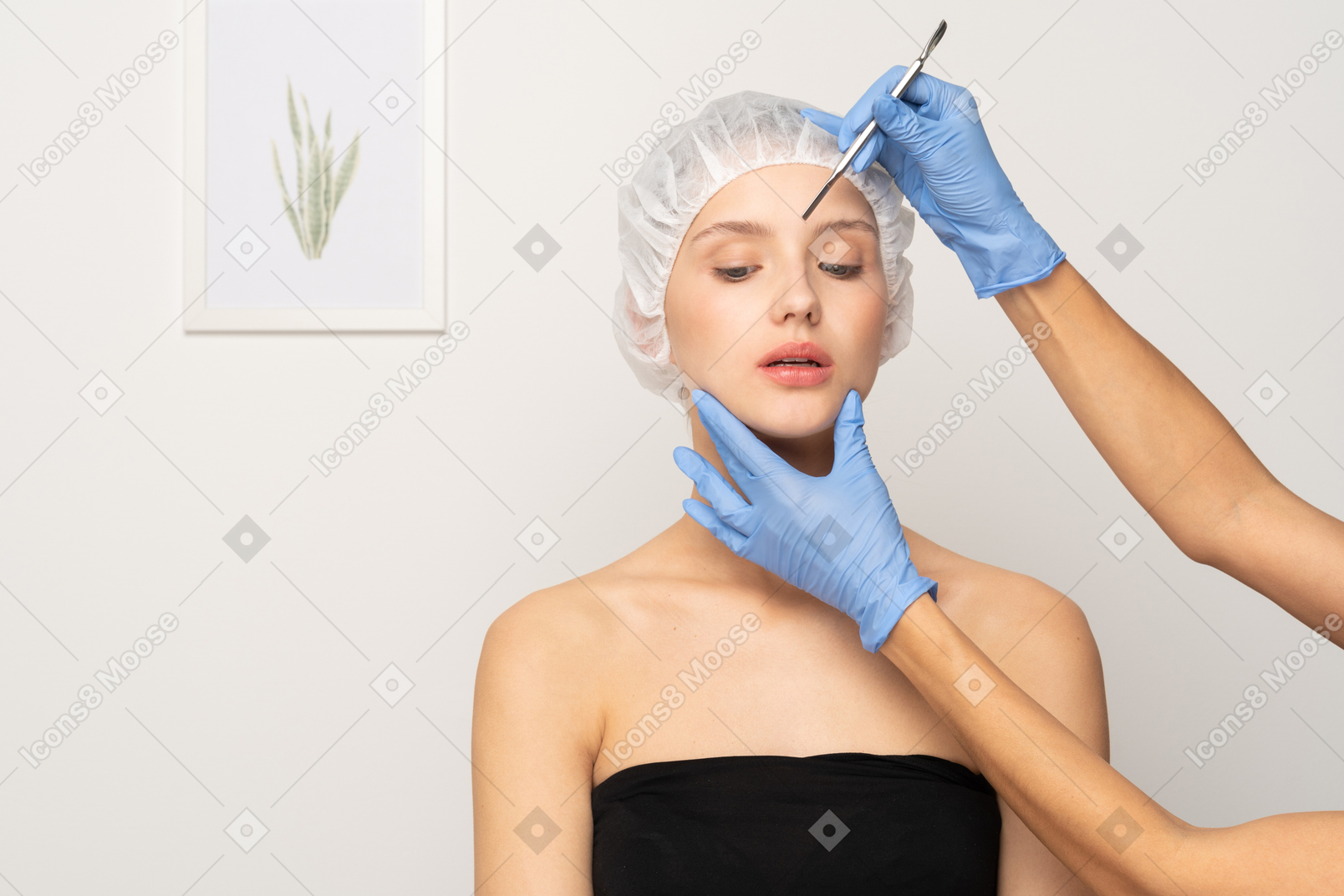 Plastic surgeon holding scalpel near woman's face