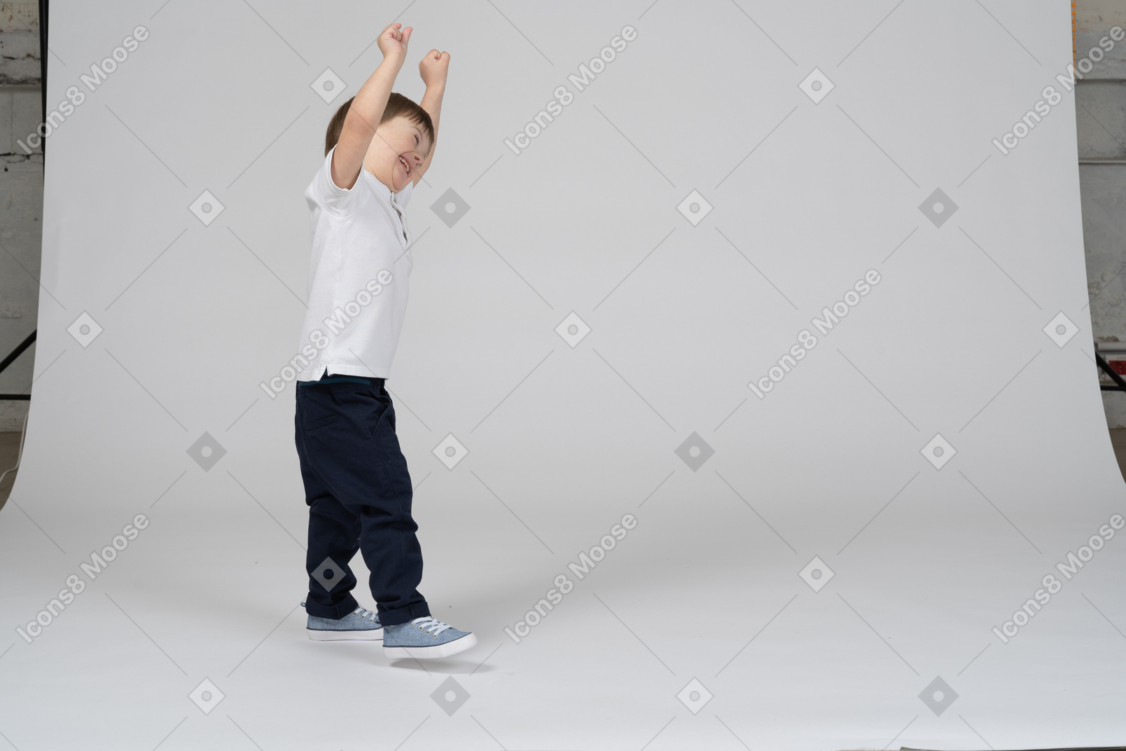 Little boy celebrating with his arms raised