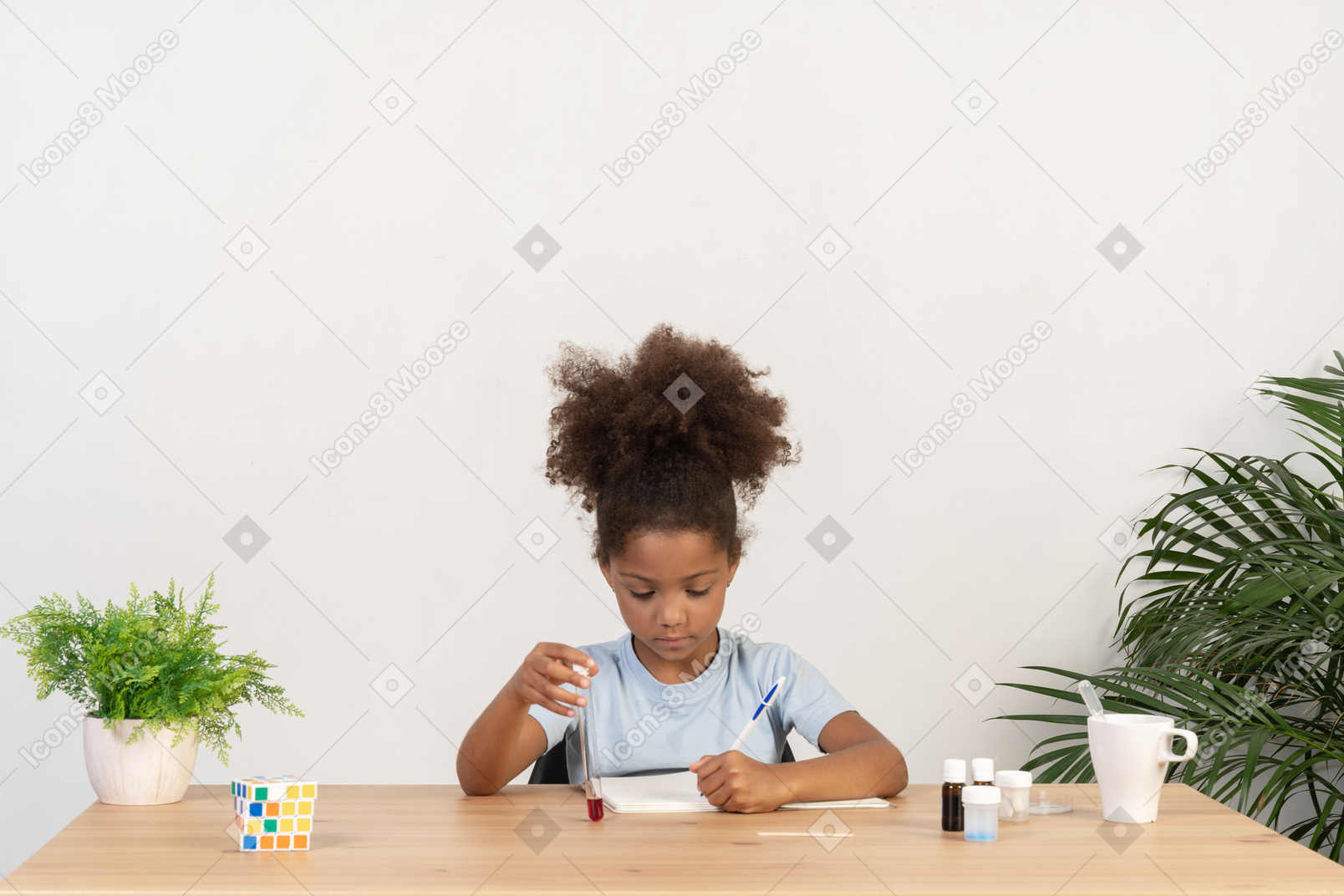 Good looking cute girl doing science at the table