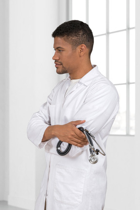A man in a white lab coat with a stethoscope