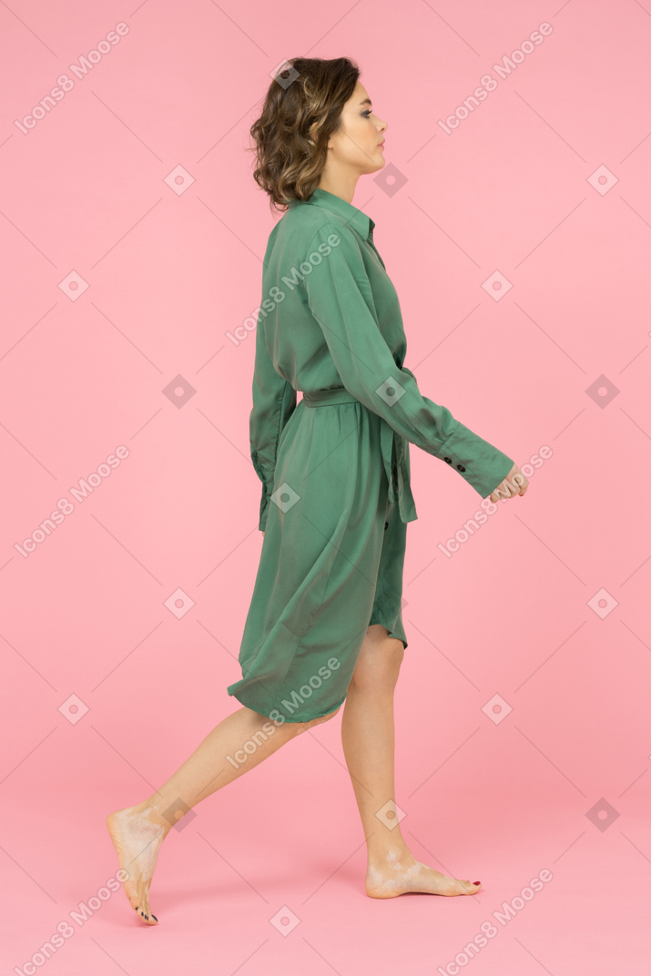 Confident brunette female walking sideways