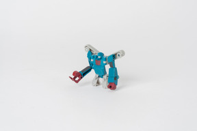 A toy transformer figure of blue and white colours standing against a plain white background