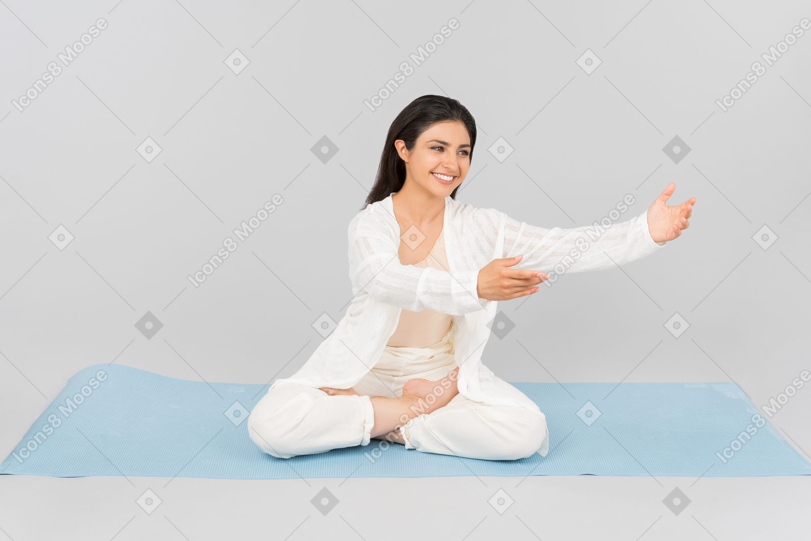 Young indian woman in yoga clothes outstretching a hand