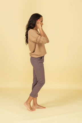 Side view of a young dark-skinned female narrowing her eyes