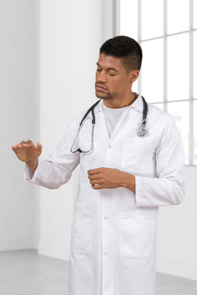 A male doctor in a white lab coat