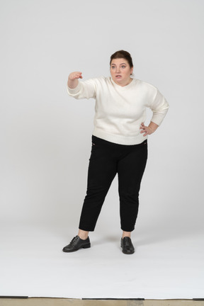Plump woman in casual clothes talking to someone