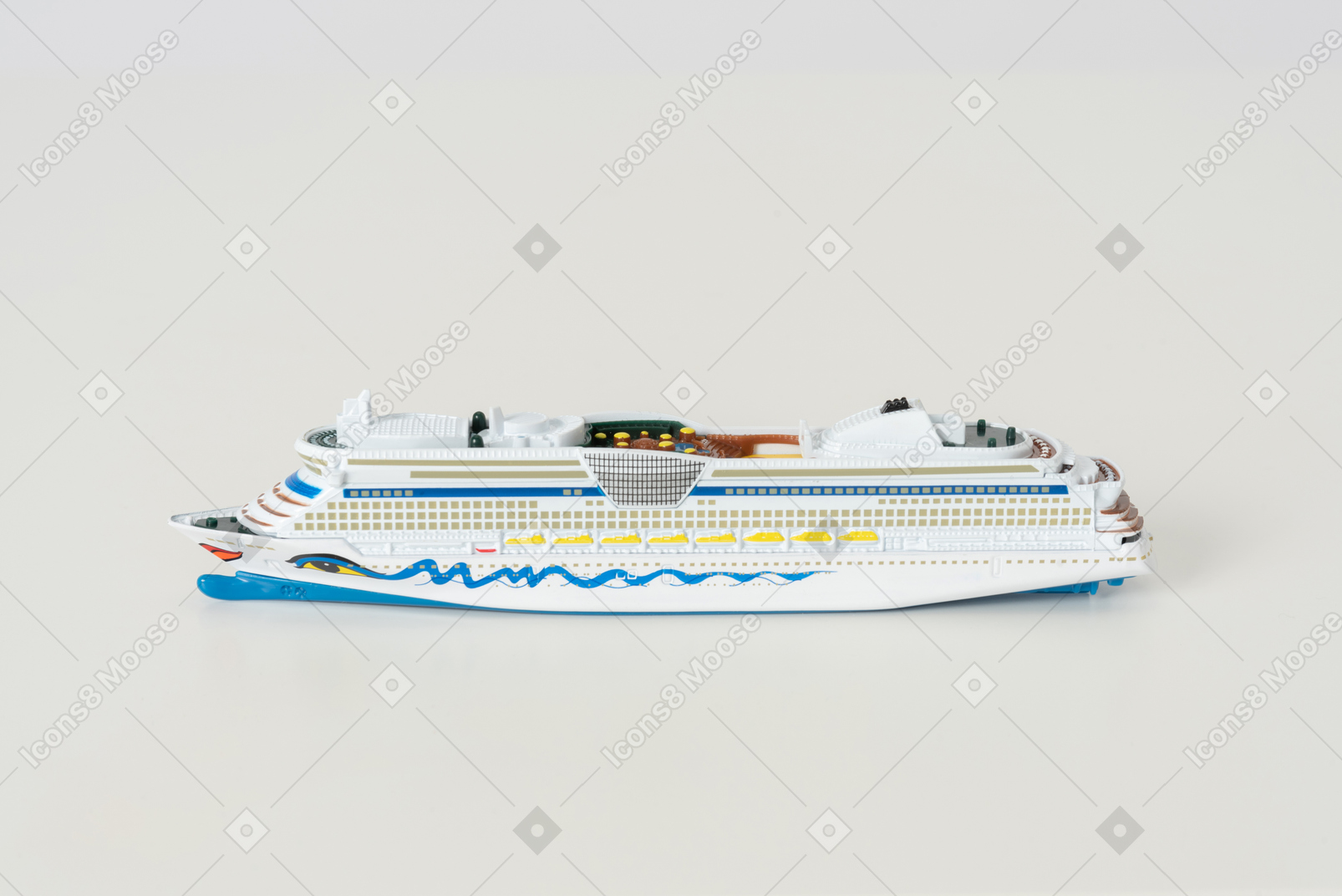 The toy cruise ship on the light grey background