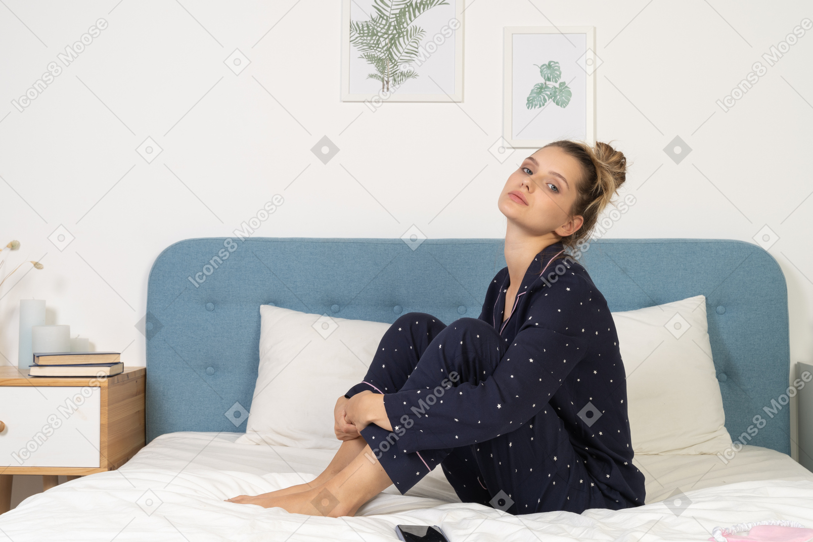 Side view of a bored young lady in pajamas staying in bed