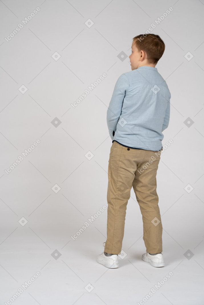 Boy standing back to camera