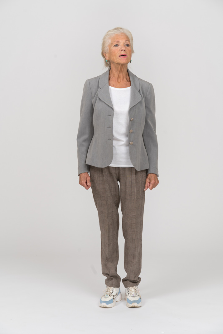 Front view of an old woman in grey jacket asking something