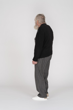 Side view of a standing senior man