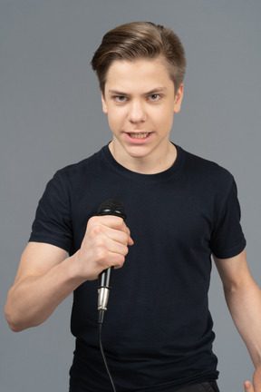 Young man speaking into microphone