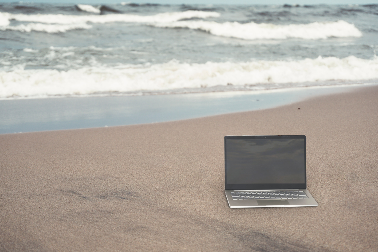 Macbook pro at the sandy beach