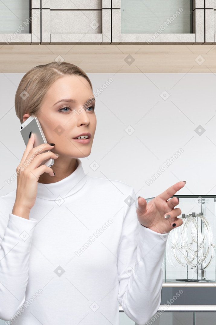 A woman talking on a cell phone in a building