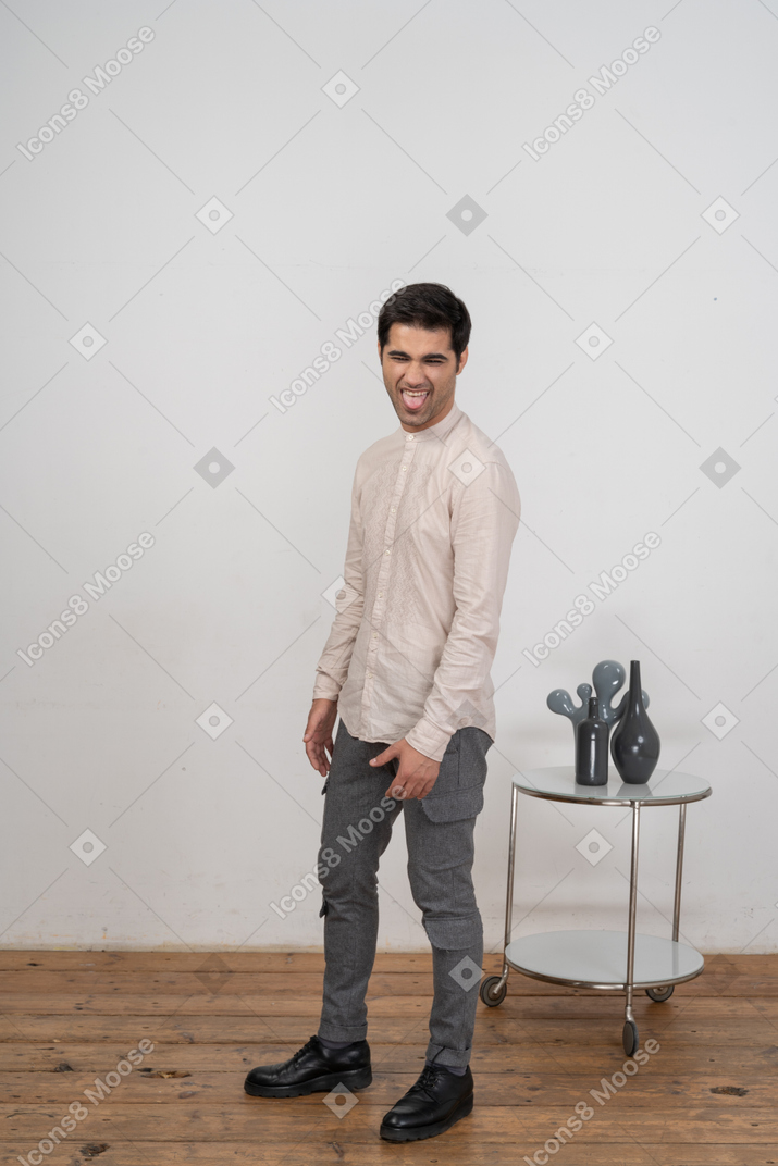 Front view of a happy man in casual clothes making faces