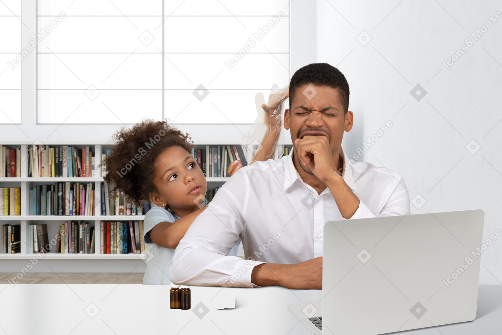 A man and a little girl sitting in front of a laptop computer