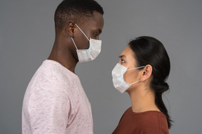 A young couple wearing face masks