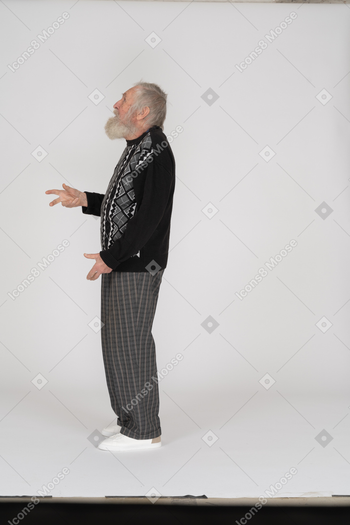 Side view of senior man looking up and gesturing