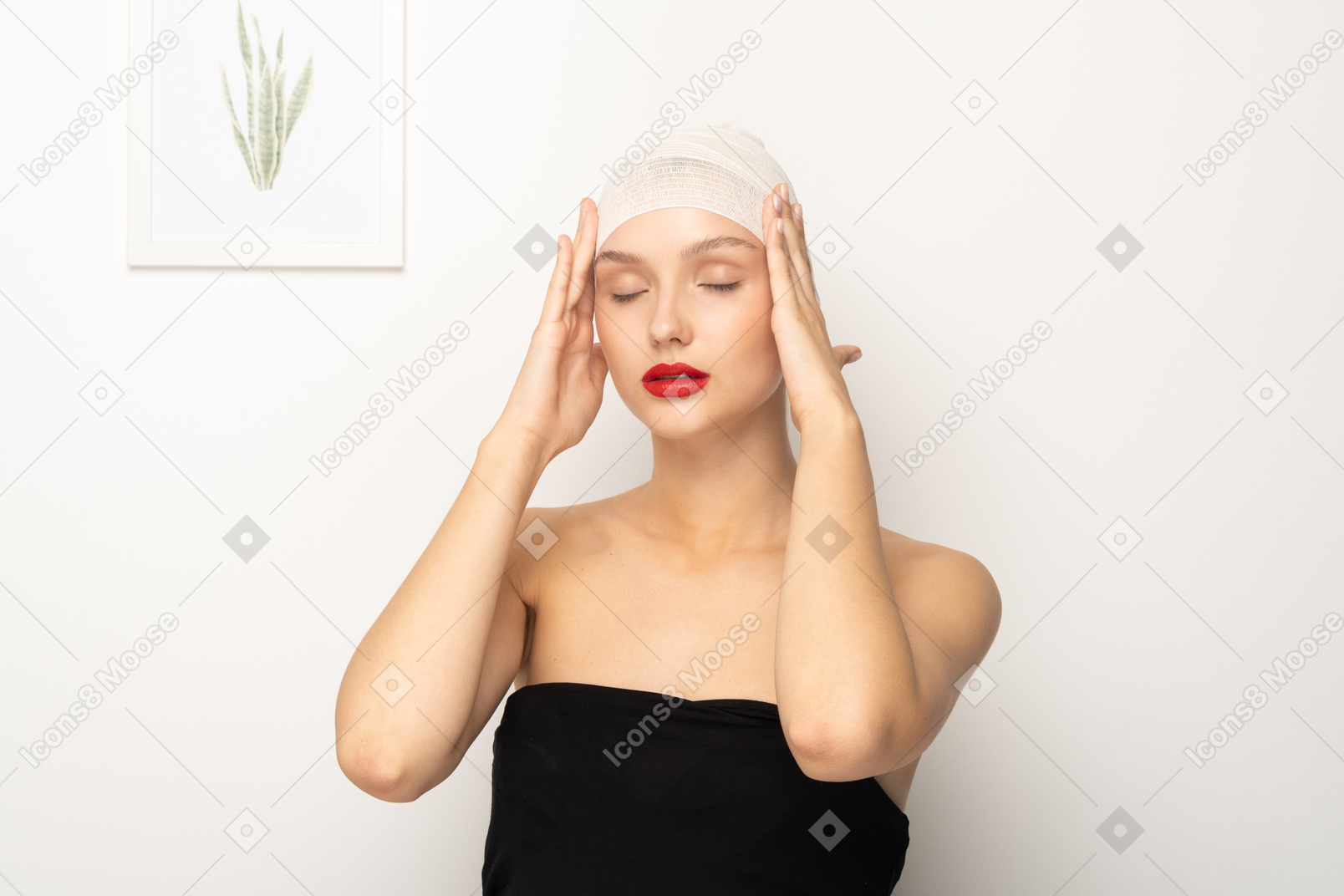 Young woman with bandaged head touching temples