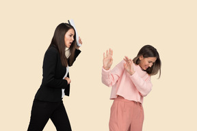 Angry young woman attacking another woman