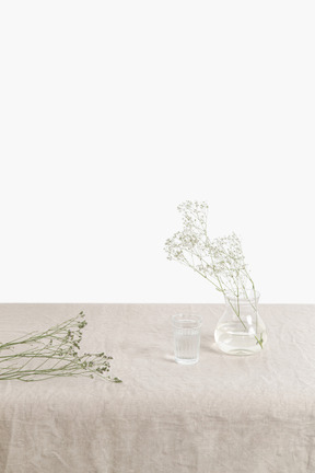 Glass vase with twig and dried twigs on the table