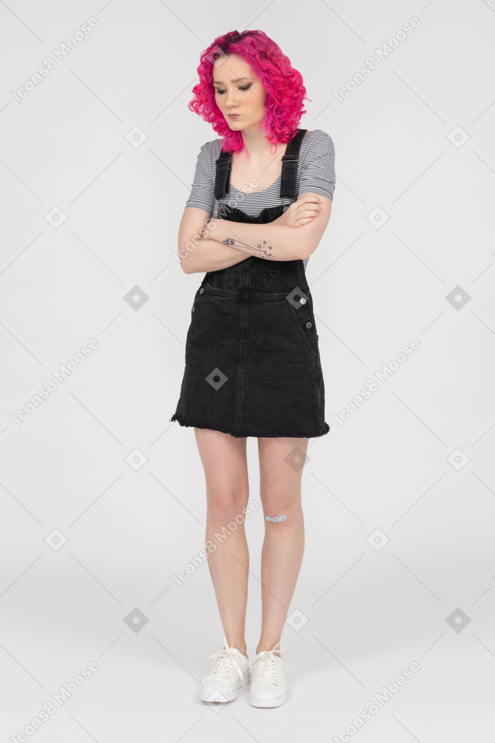 Offended teenage girl posing with her arms crossed