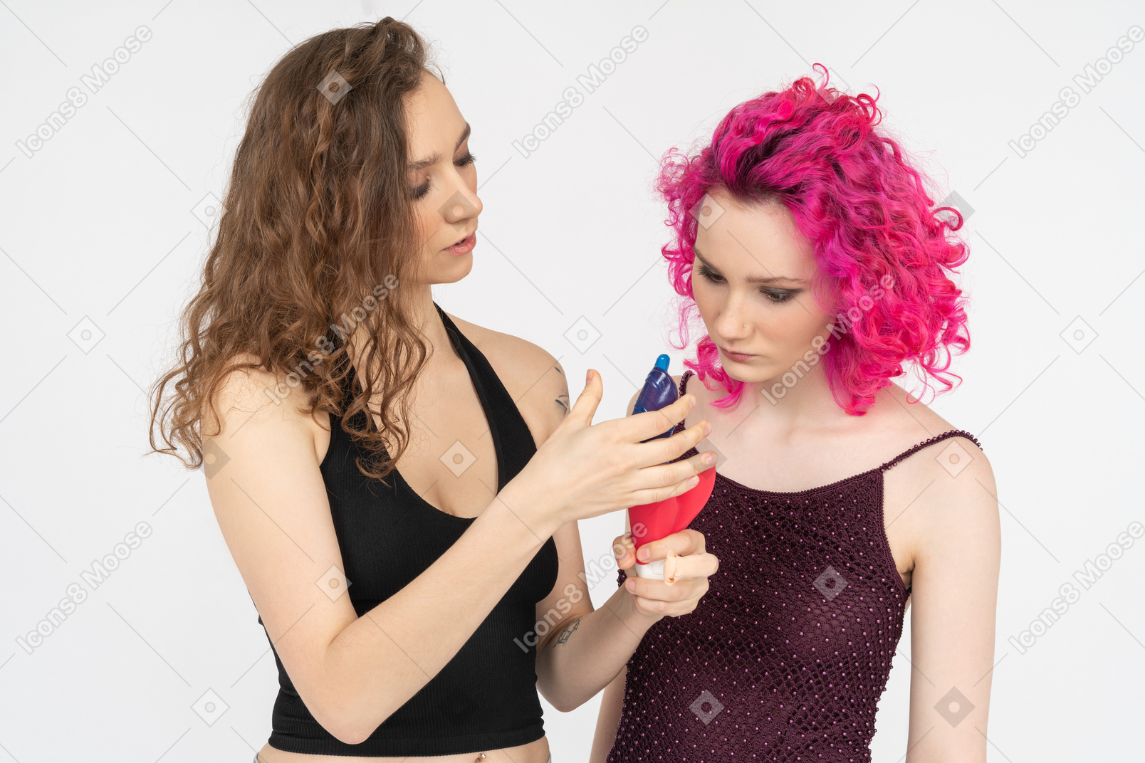 Elder sister teaching younger one to use condoms