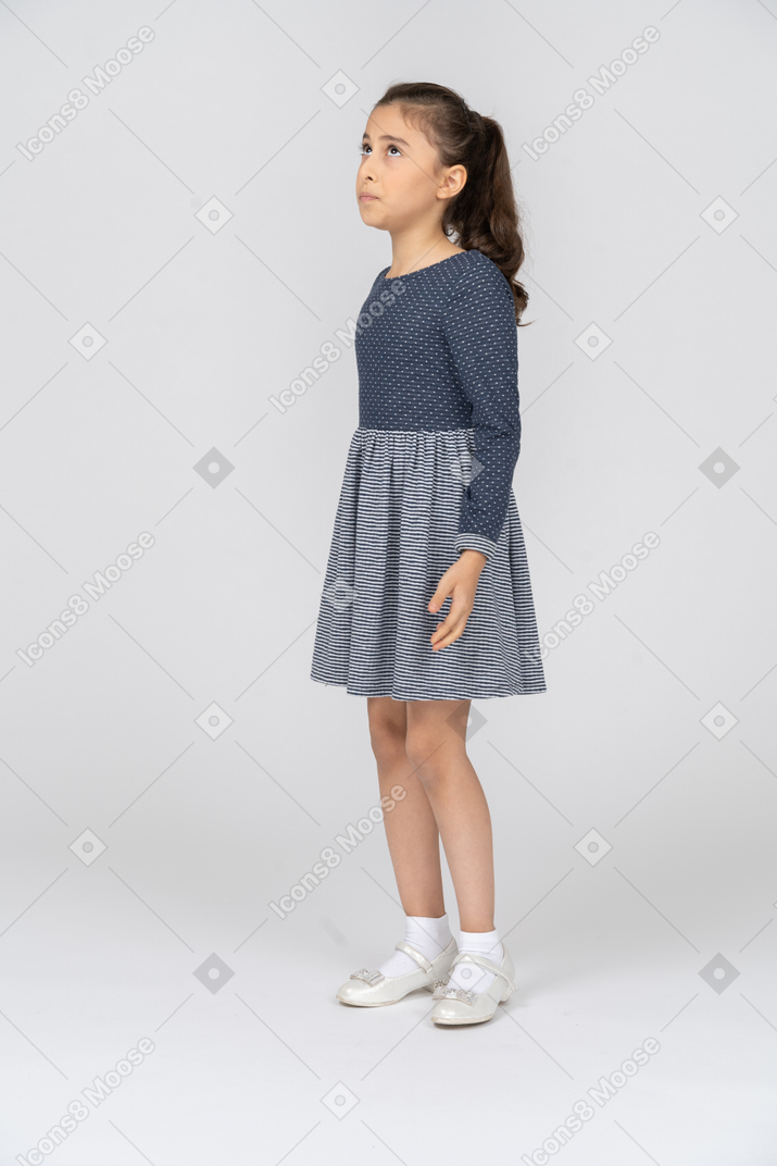 Three-quarter view of a girl looking up intensely