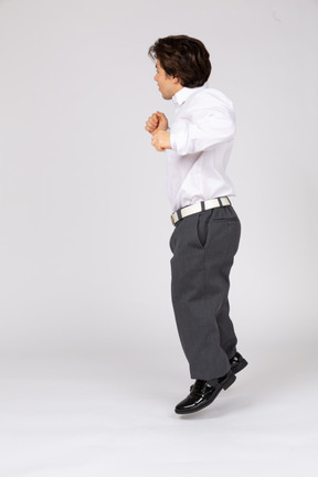 Side view of young man jumping