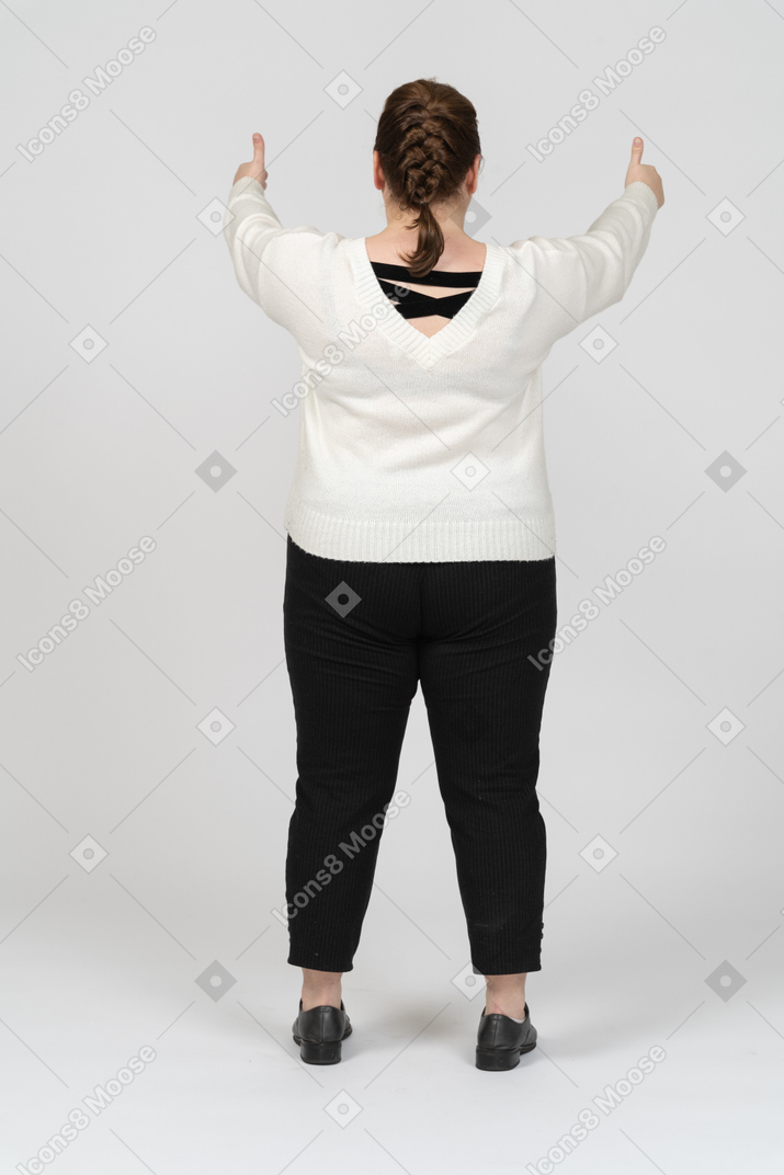 Plump woman in casual clothes showing thumbs up