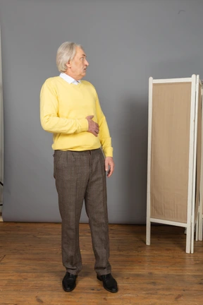 Front view of an old staring scared man looking aside