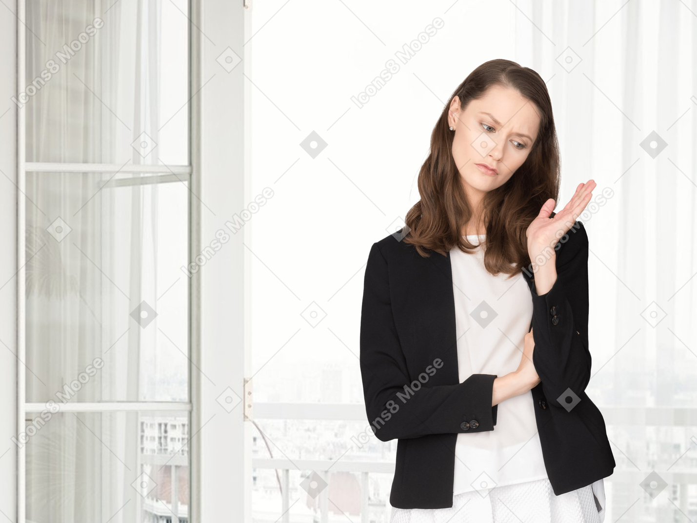 Confused woman standing in front of a window