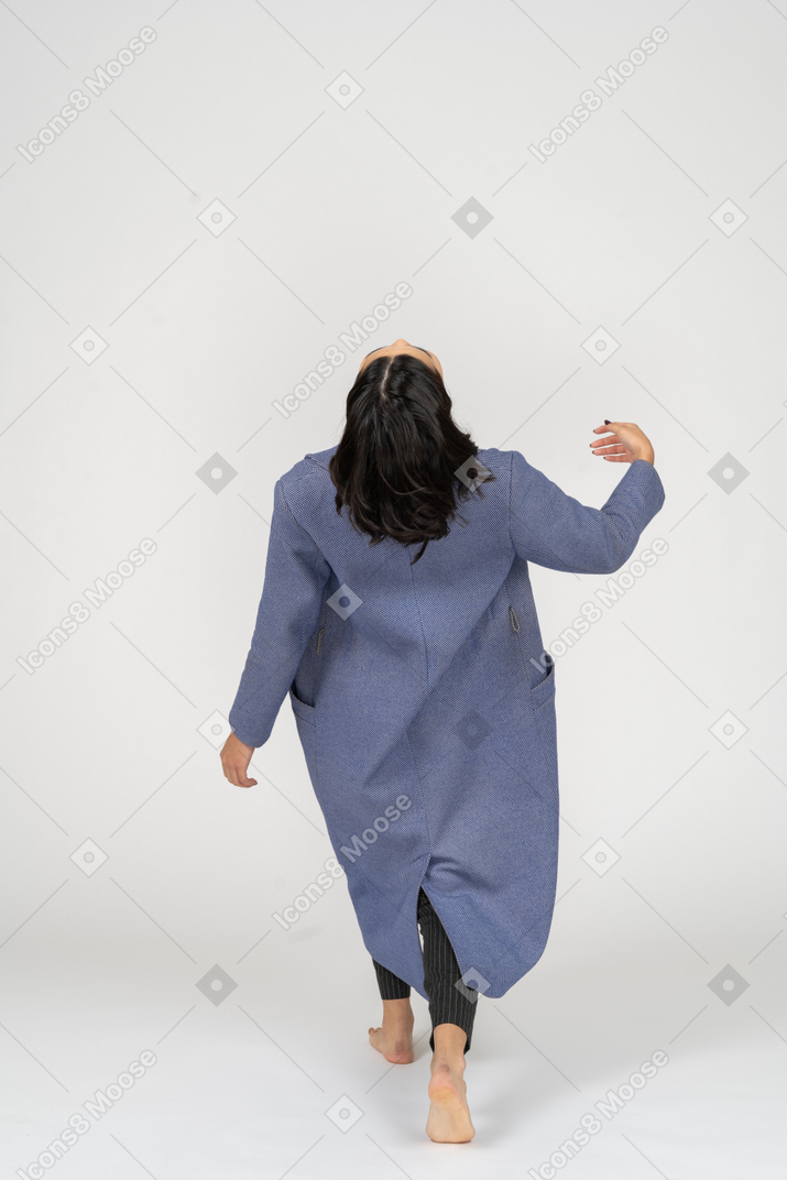 Woman in coat falling back