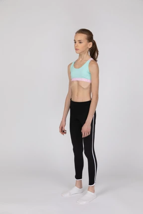 Side view of a teen girl in sportswear raising hand and arguing