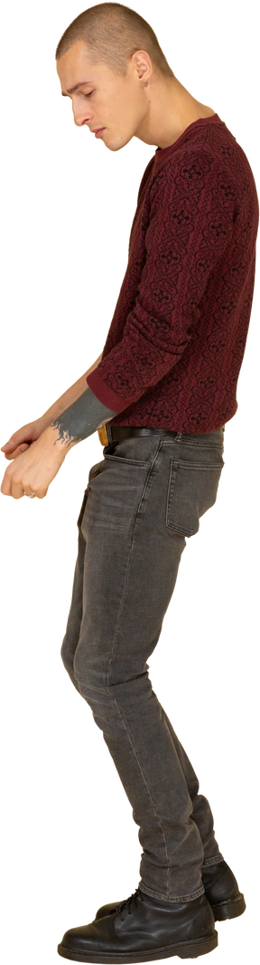 Side view of a dancing young man in red pullover