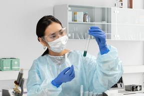 A woman in a lab holding a test tube