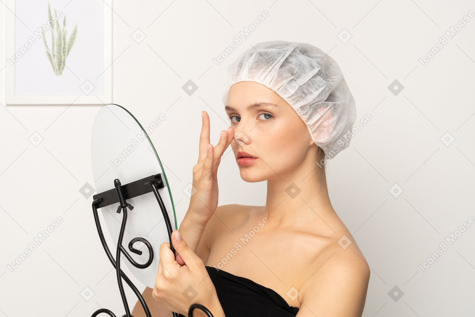 Young woman in medical cap lifting her nose