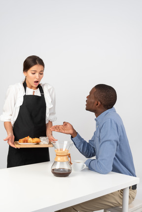 Disgruntled customer telling a waitress off for messing up his order