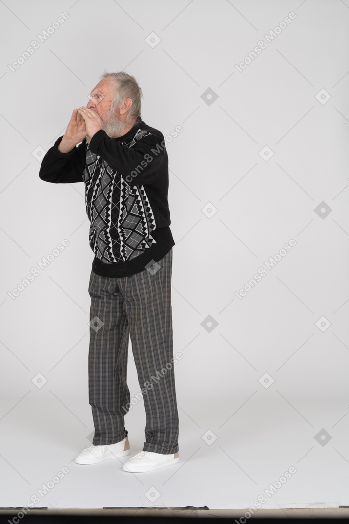 Shouting elderly man with cupped hands around mouth