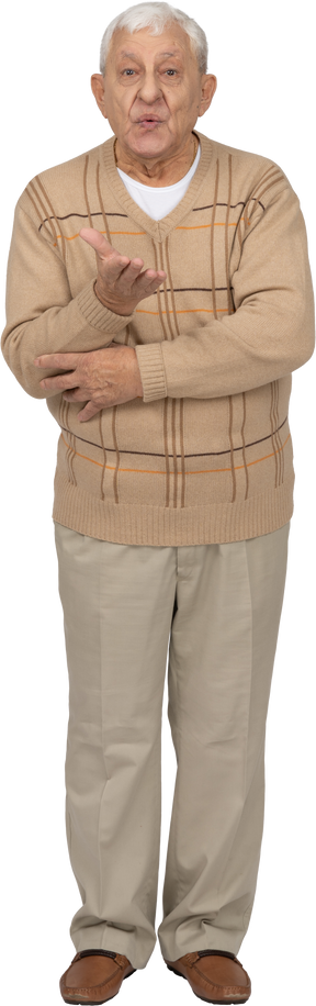 Front view of an old man in casual clothes explaining something