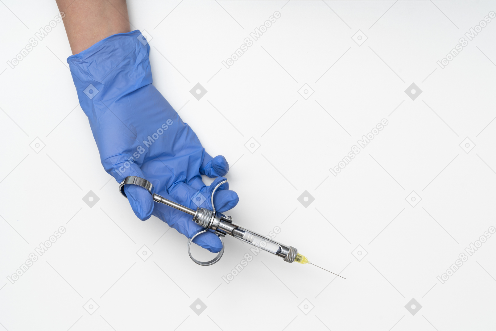 Hand in surgical glove holding a syringe