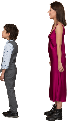 Boy and woman standing still in profile