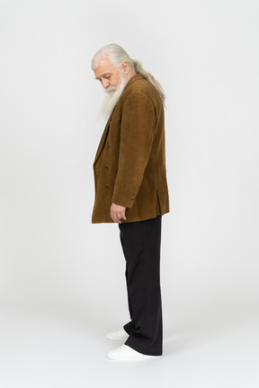 Side view of an old man looking down