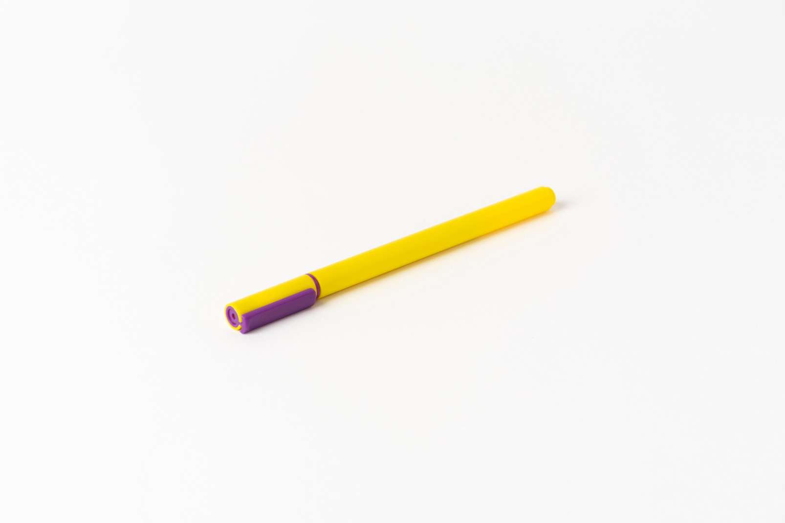 Yellow pencil on white background