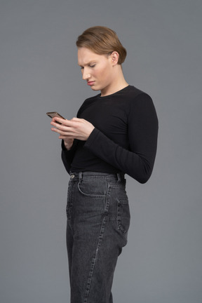 Side view of a frowning person using phone