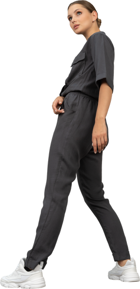 Side view of a bossy young woman in a jumpsuit